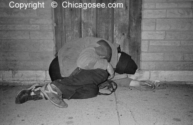 Homeless man sleeping on street, Chicago