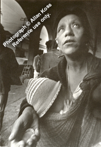 Woman begging with baby in her arms, Mexico
