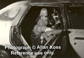 Girl posing in burnt out car, Chicago oddball