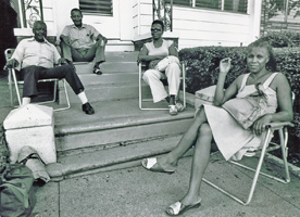 Afroamericans watch passing protest march, July 4, 1976