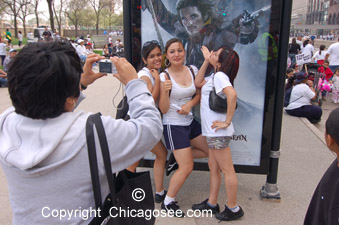 Girls posing by moviestar poster, Chicago, 2007